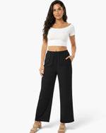 Beach Rose Co. relaxed fit black wide-leg cotton pants with side pockets worn by a model with a white crop top
