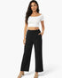 Beach Rose Co. relaxed fit black wide-leg cotton pants with side pockets worn by a model with a white crop top