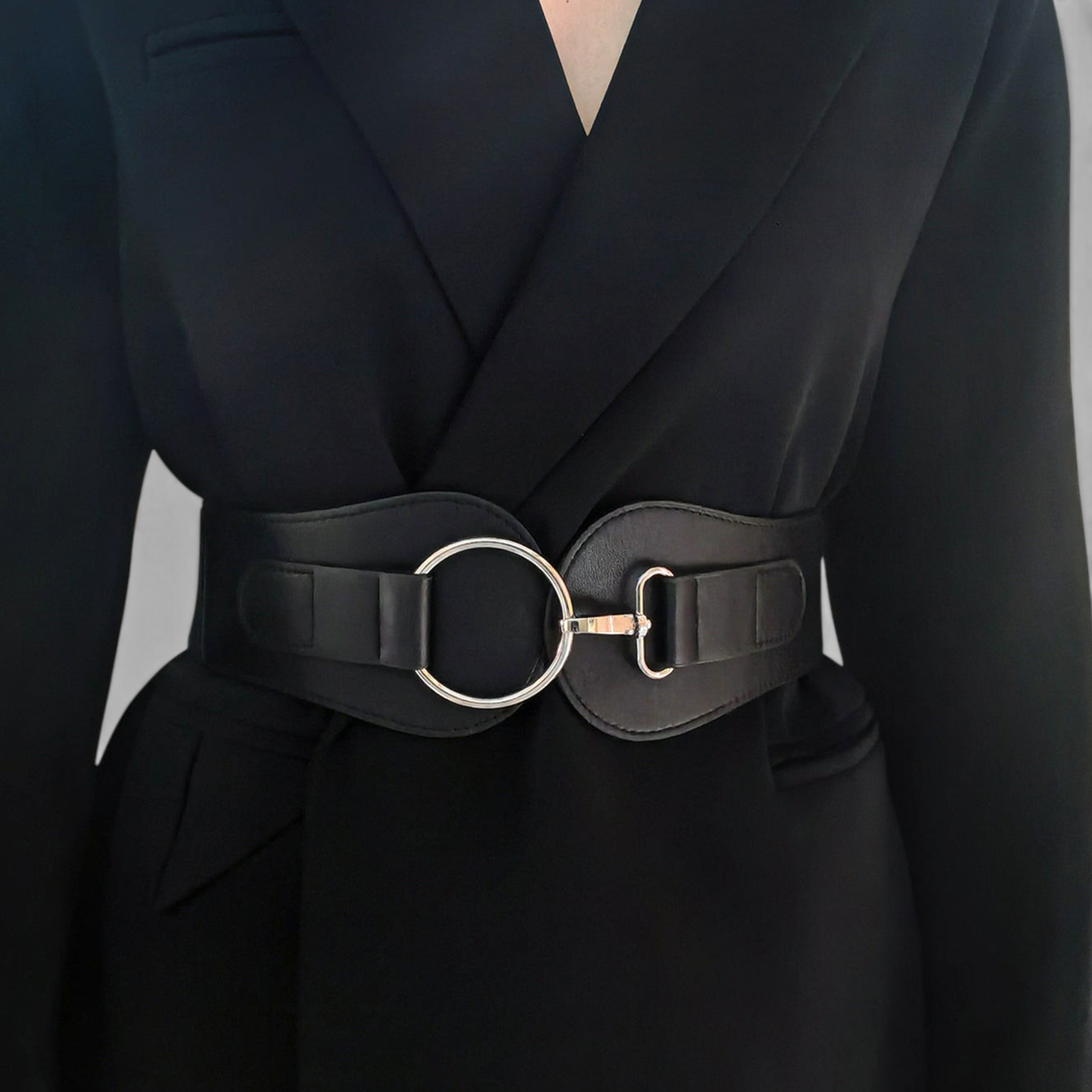 Beach Rose Co. wide black waist belt with a silver-tone ring buckle and lobster clasp worn over a black blazer.
