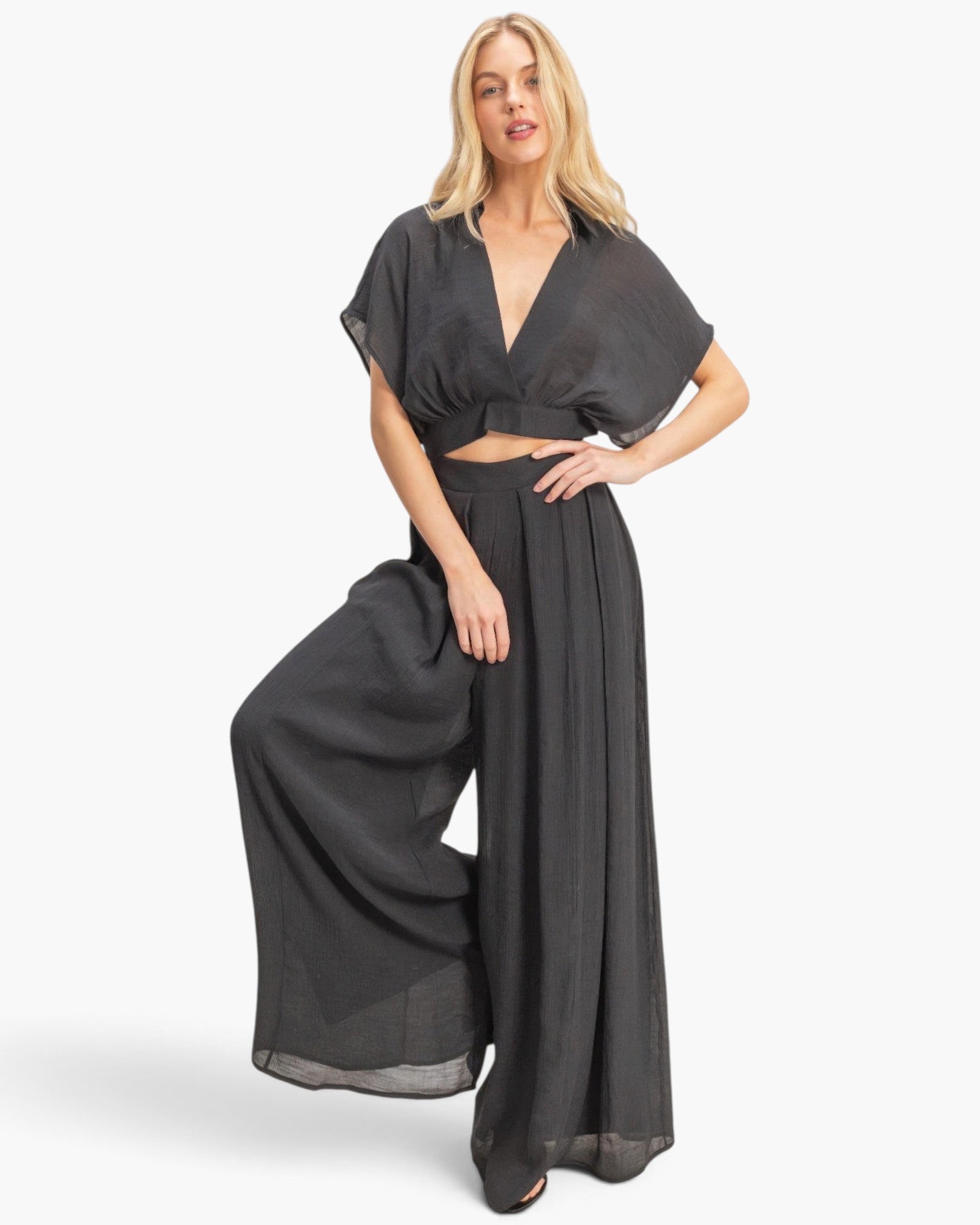 Beach Rose Co. black two-piece set with a collared cropped wrap top and flowing wide-leg pleated pants on a model.