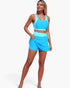 Beach Rose Co. two-piece bikini with a blue color block sports bra top and high-waisted skirted bottoms on a model