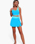 Beach Rose Co. blue color block two-piece bikini with a high-waisted skirt bottom and tie-up detail on a model