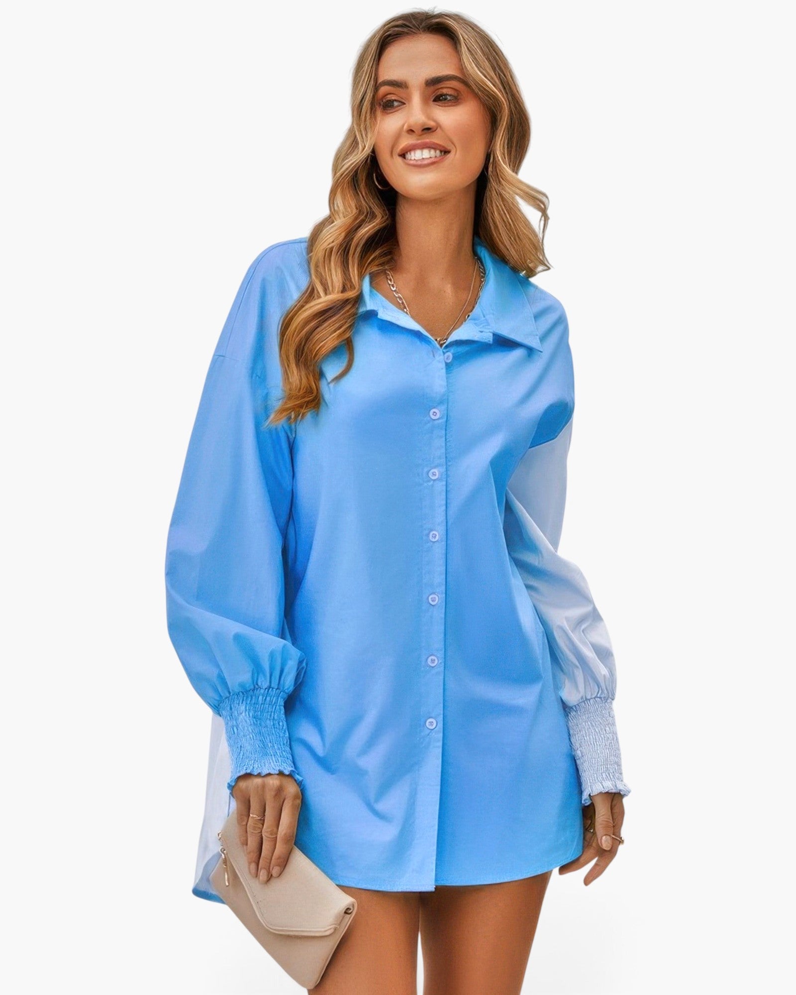Beach Rose Co. blue color block button down blouse with cuffed sleeves worn by a smiling woman outdoors