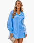 Beach Rose Co. blue color block button down blouse with cuffed sleeves worn by a smiling woman outdoors
