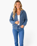 Beach Rose Co. blue corduroy zip-front hooded jacket with chest pocket and elastic cuffs worn by a smiling model