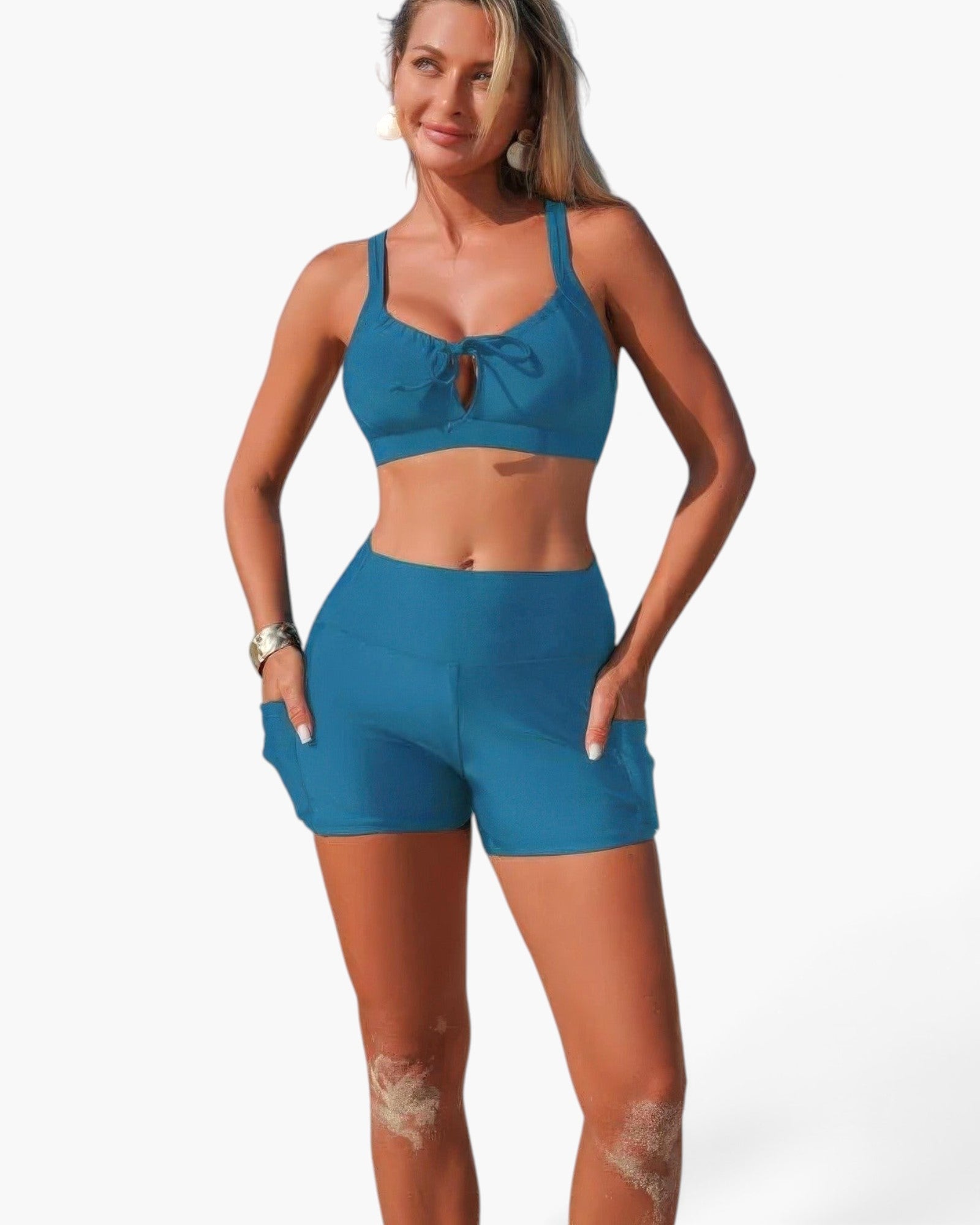 Beach Rose Co. blue two-piece bikini with a crisscross top and high-waisted shorts featuring side pockets.