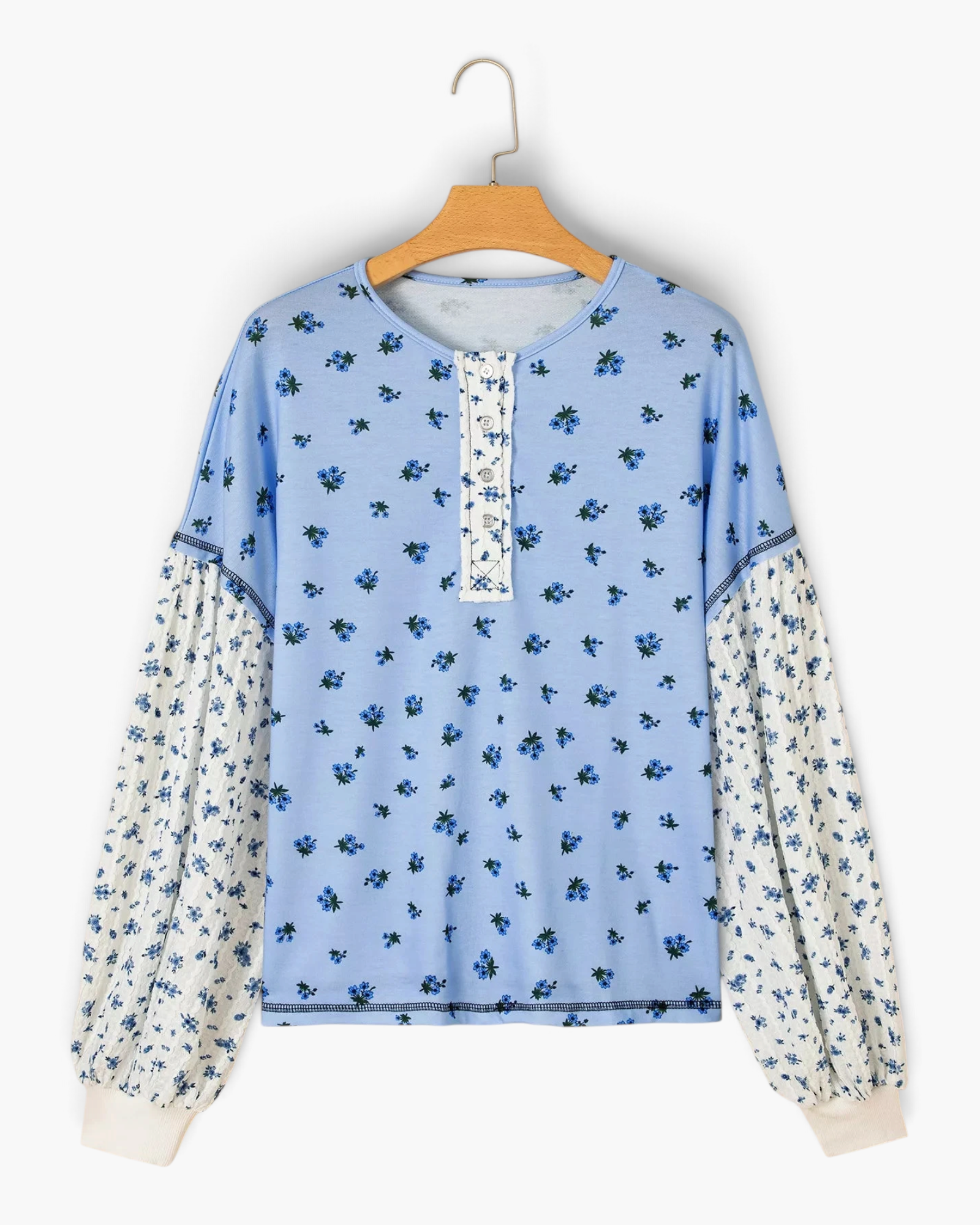 Beach Rose Co. blue floral print long sleeve top with buttoned placket and contrasting puff sleeves in soft fabric.