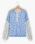 Beach Rose Co. blue floral print long sleeve top with buttoned placket and contrasting puff sleeves in soft fabric.