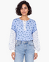 Beach Rose Co. blue floral print long sleeve top with a buttoned placket and contrasting patterned sleeves.