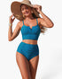 Beach Rose Co. blue two-piece bikini with high-waisted pleated bottoms and strap top worn by a model with a sun hat.
