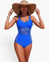 Beach Rose Co. blue one-piece swimsuit with sheer mesh panels, ring-accented straps, and tummy-control fit on model.