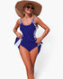 Beach Rose Co. blue one-piece swimsuit with patchwork side panels and tie-up waist worn by a woman in a sun hat.