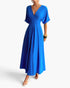 Beach Rose Co. blue pleated A-line full dress with batwing sleeves and a deep V-neckline worn by a model.