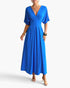 Beach Rose Co. royal blue pleated A-line maxi dress with batwing sleeves and a deep V-neckline on a model.