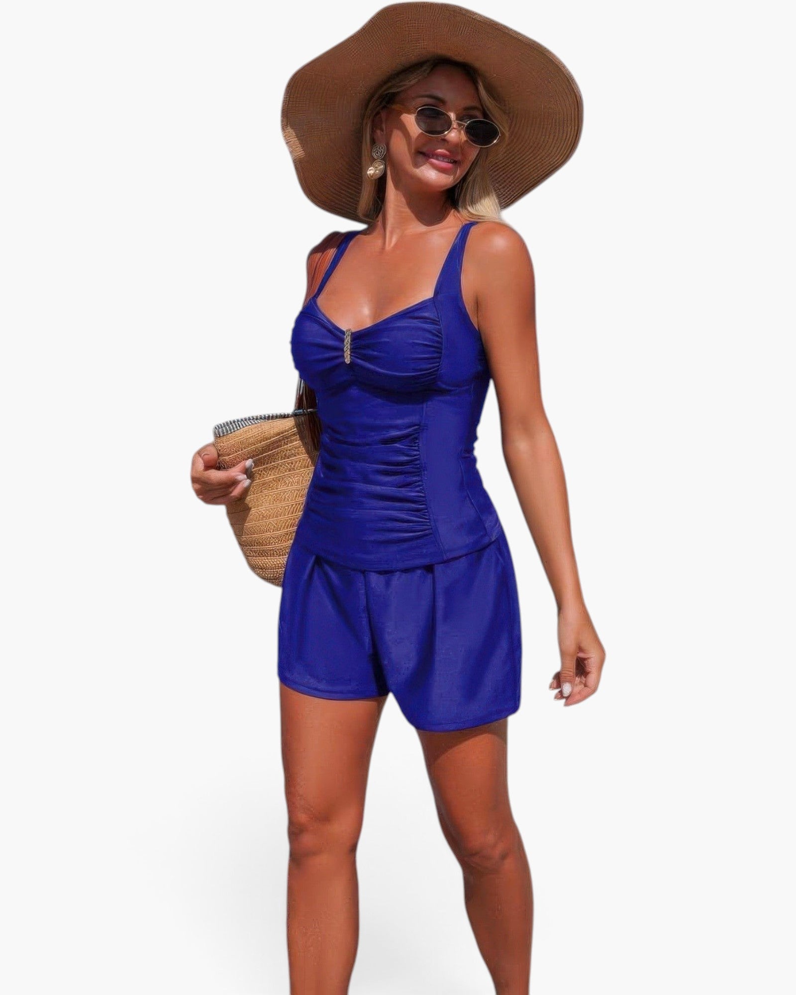 Beach Rose Co. blue two-piece swimsuit with pleated tank top and shorts, worn by a woman with a sun hat and bag.