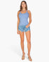 Beach Rose Co. model wearing a light blue ribbed knit cami top with denim shorts against a white background