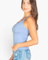 Beach Rose Co. model wearing a light blue ribbed knit cami top with a scoop neckline and fitted silhouette