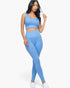 Beach Rose Co. blue ribbed crop top and high-waisted leggings set worn by a model on a white background