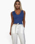 Beach Rose Co. blue ribbed V-neck sleeveless top worn by a blonde model with white trousers