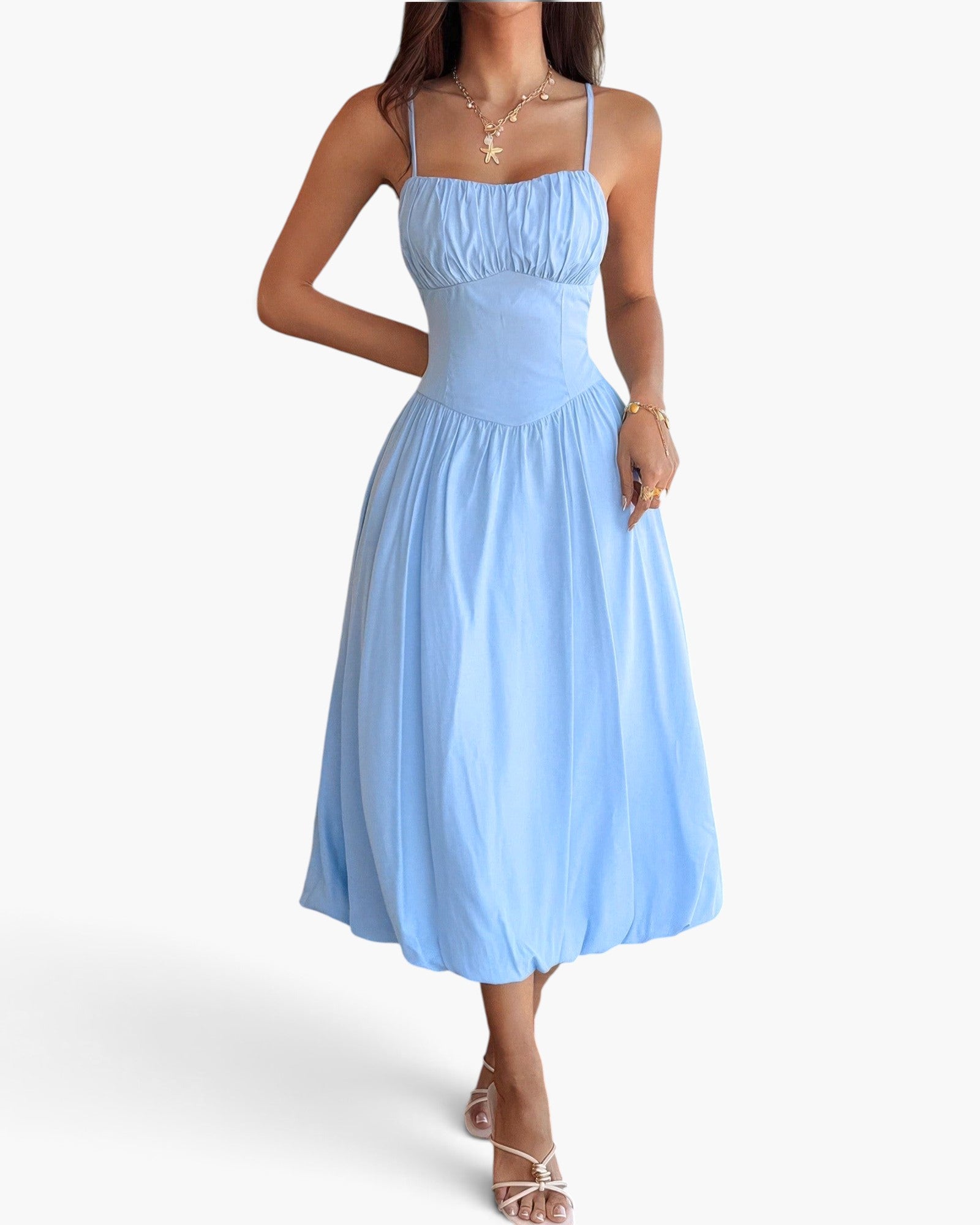 Beach Rose Co. light blue sleeveless A-line dress with a ruched bust, worn by a model with gold jewelry.