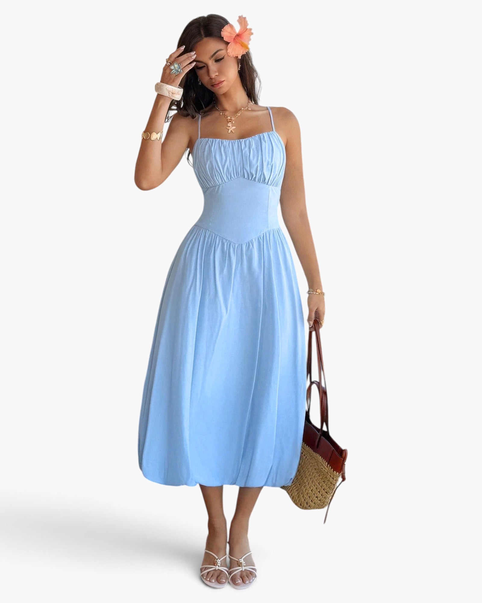 Beach Rose Co. light blue sleeveless A-line midi dress with a ruched bust, worn by a model with a floral hair clip.