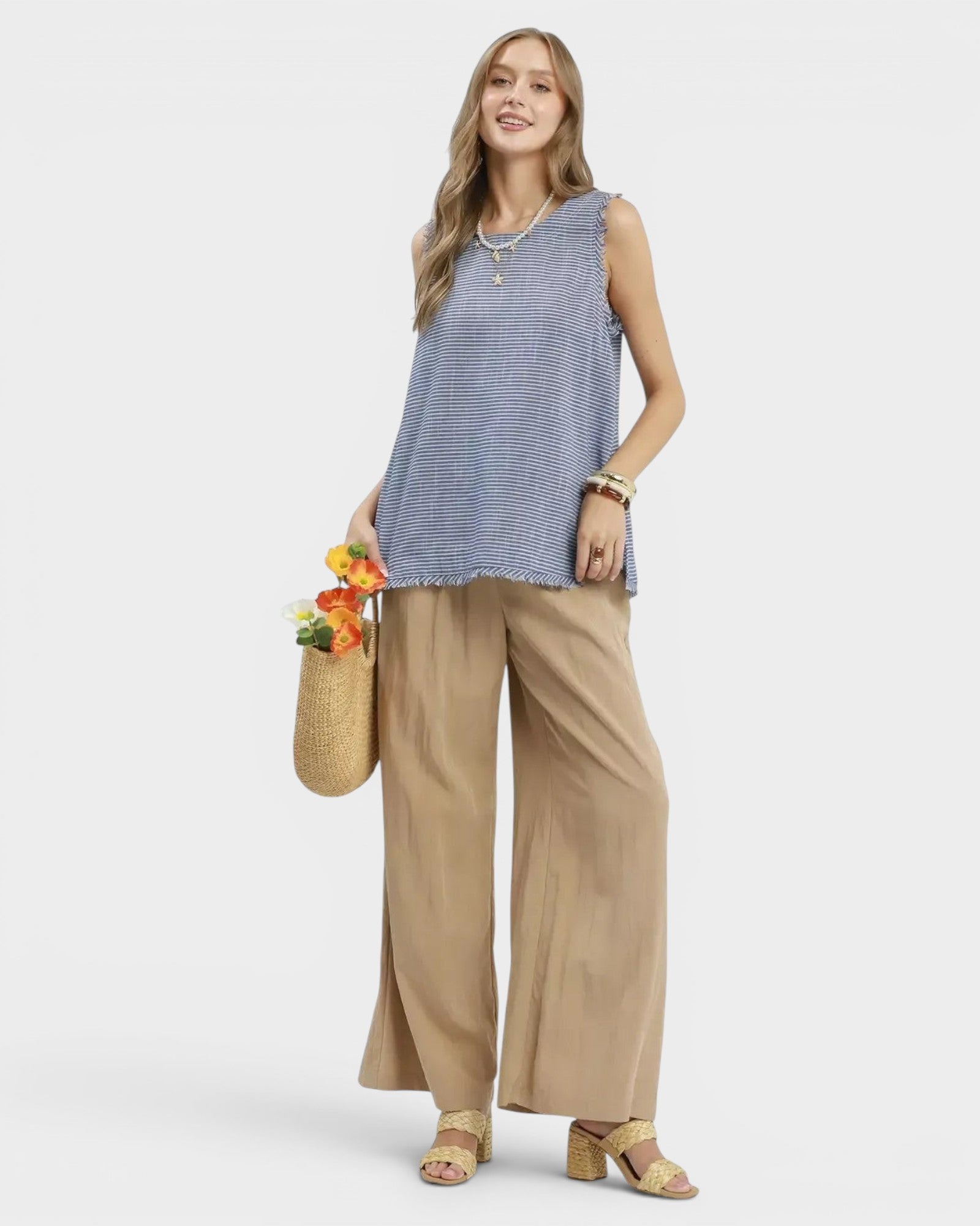 Beach Rose Co. blue and white striped linen blend sleeveless top with fringe trim and raw hem.