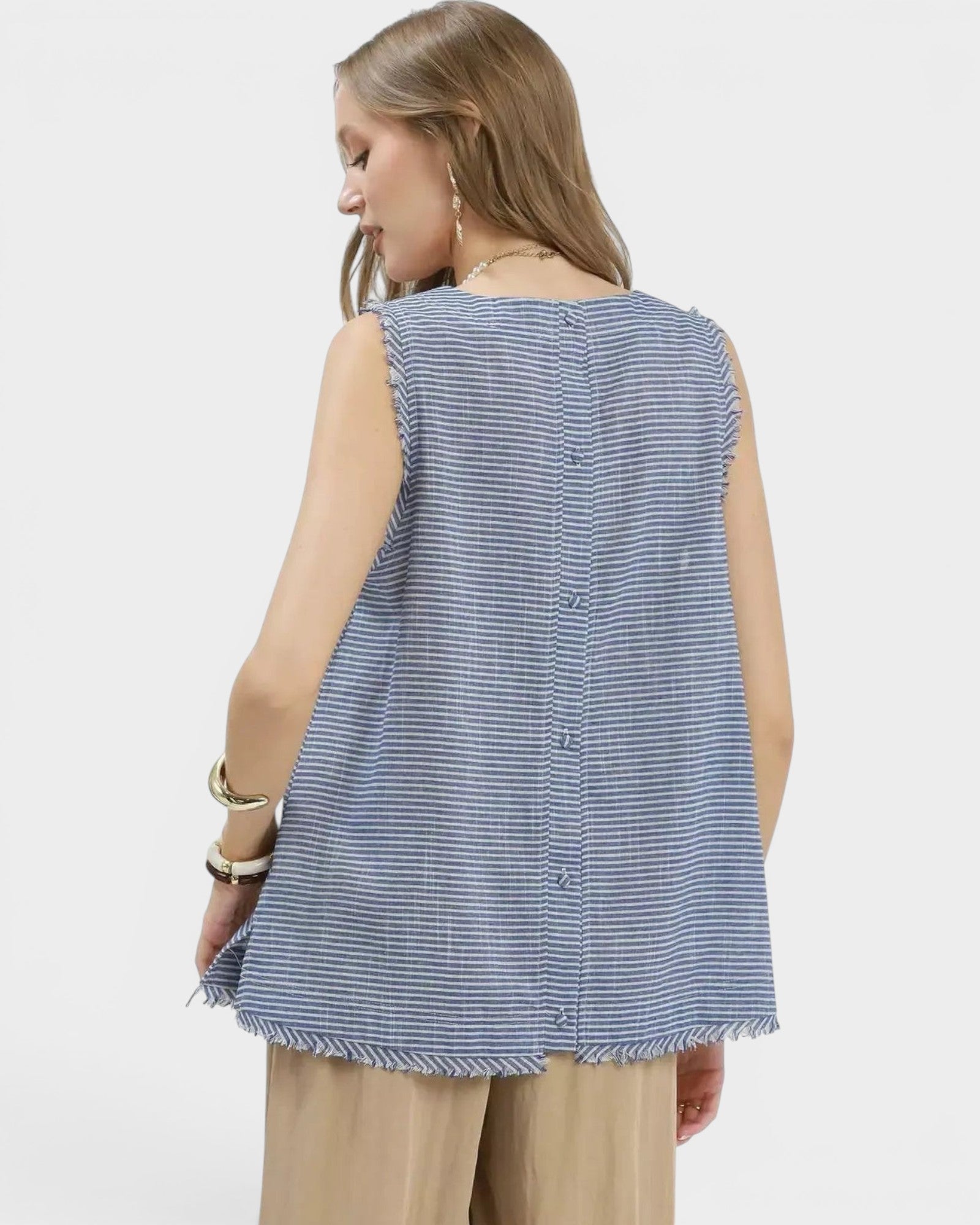 Beach Rose Co. blue and white striped linen blend sleeveless top with fringe hem and button back detail.