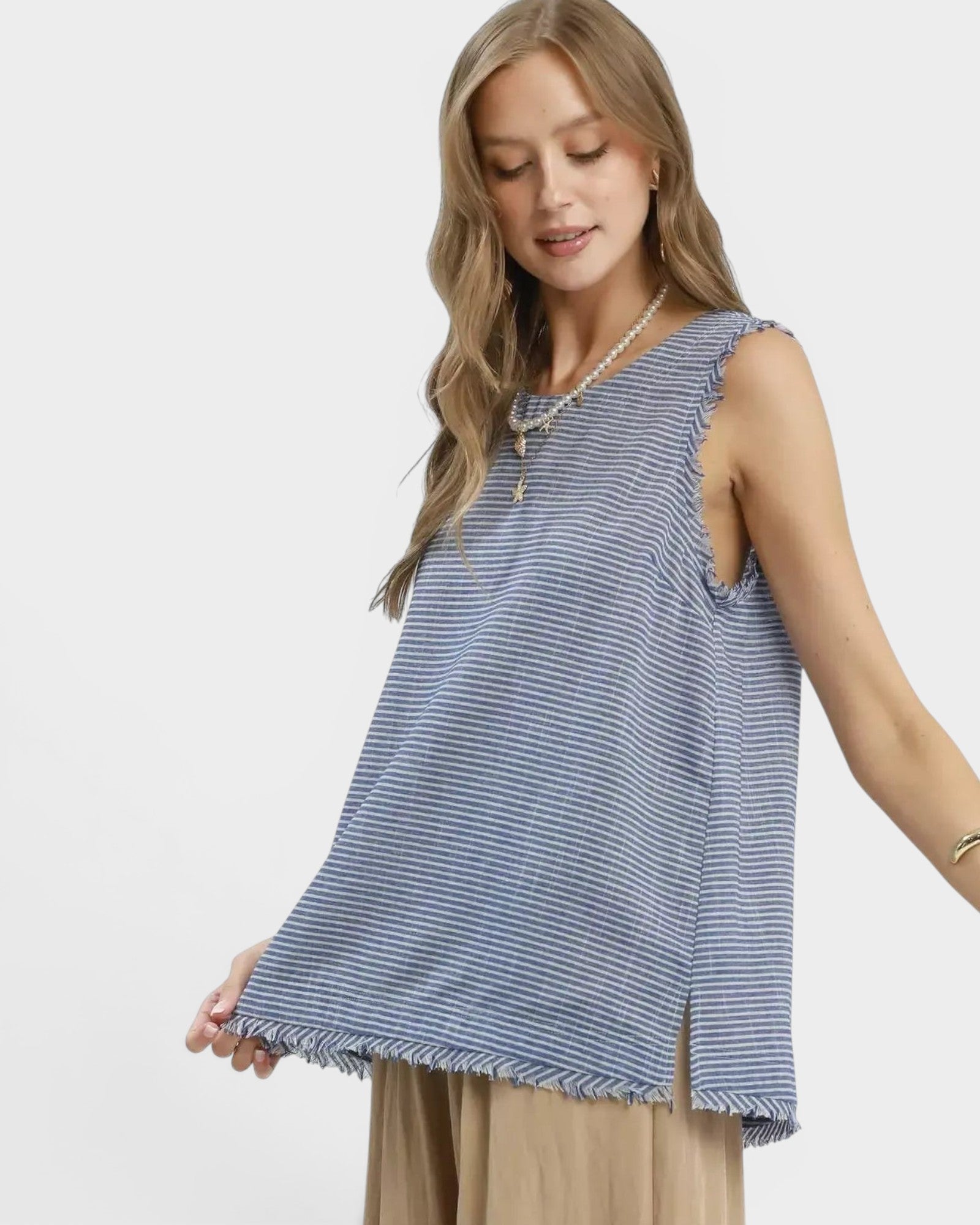 Beach Rose Co. blue and white striped linen blend sleeveless top with fringe trim and raw hem.