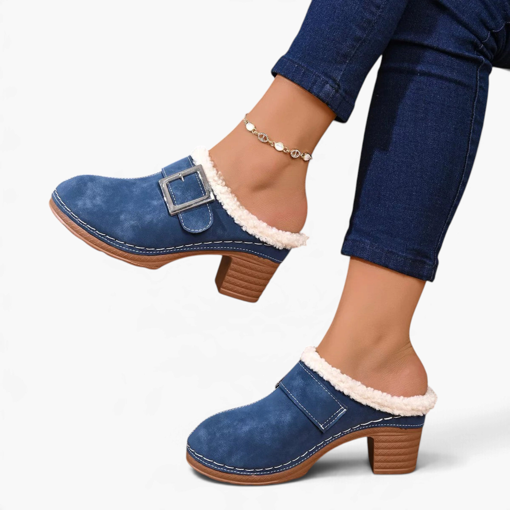 Beach Rose Co. blue suede clogs with fluffy trim, oversized buckle, and chunky block heel worn with blue jeans.