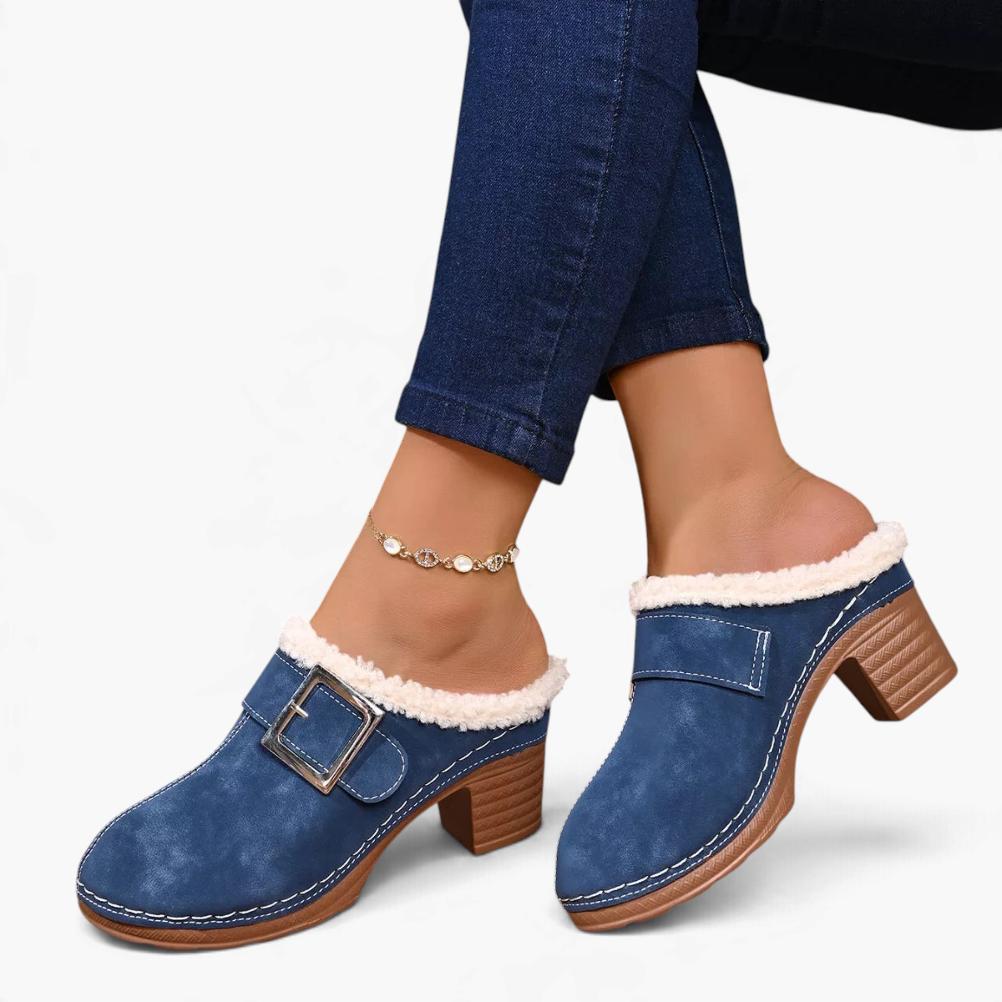 Beach Rose Co. blue suede clogs with fluffy trim, oversized buckle, and chunky block heel worn with cuffed jeans.