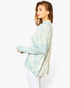 Beach Rose Co. blue tie-dye surplice hi-lo top with a choker neck worn by a model against a white background
