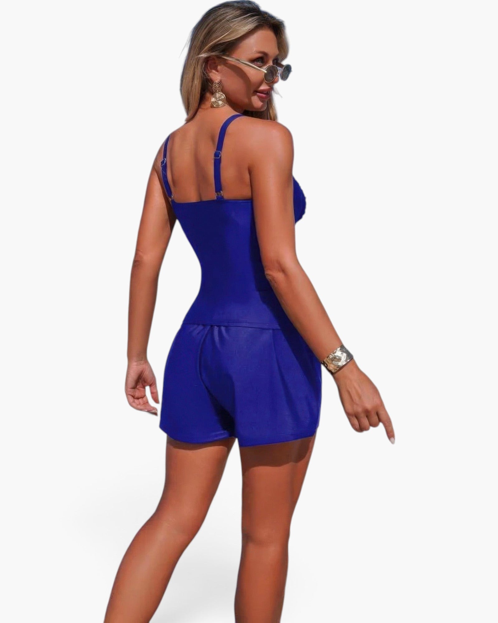 Beach Rose Co. blue two-piece swimsuit with sling straps and pleated shorts worn by a woman from the back view
