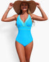 Beach Rose Co. one-piece V-neck swimsuit in bright blue with color block detail, worn by a woman with a sun hat.