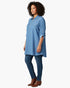 Beach Rose Co. blue zip-front tunic blouse with utility pockets and roll-tab sleeves worn by a model with jeans.