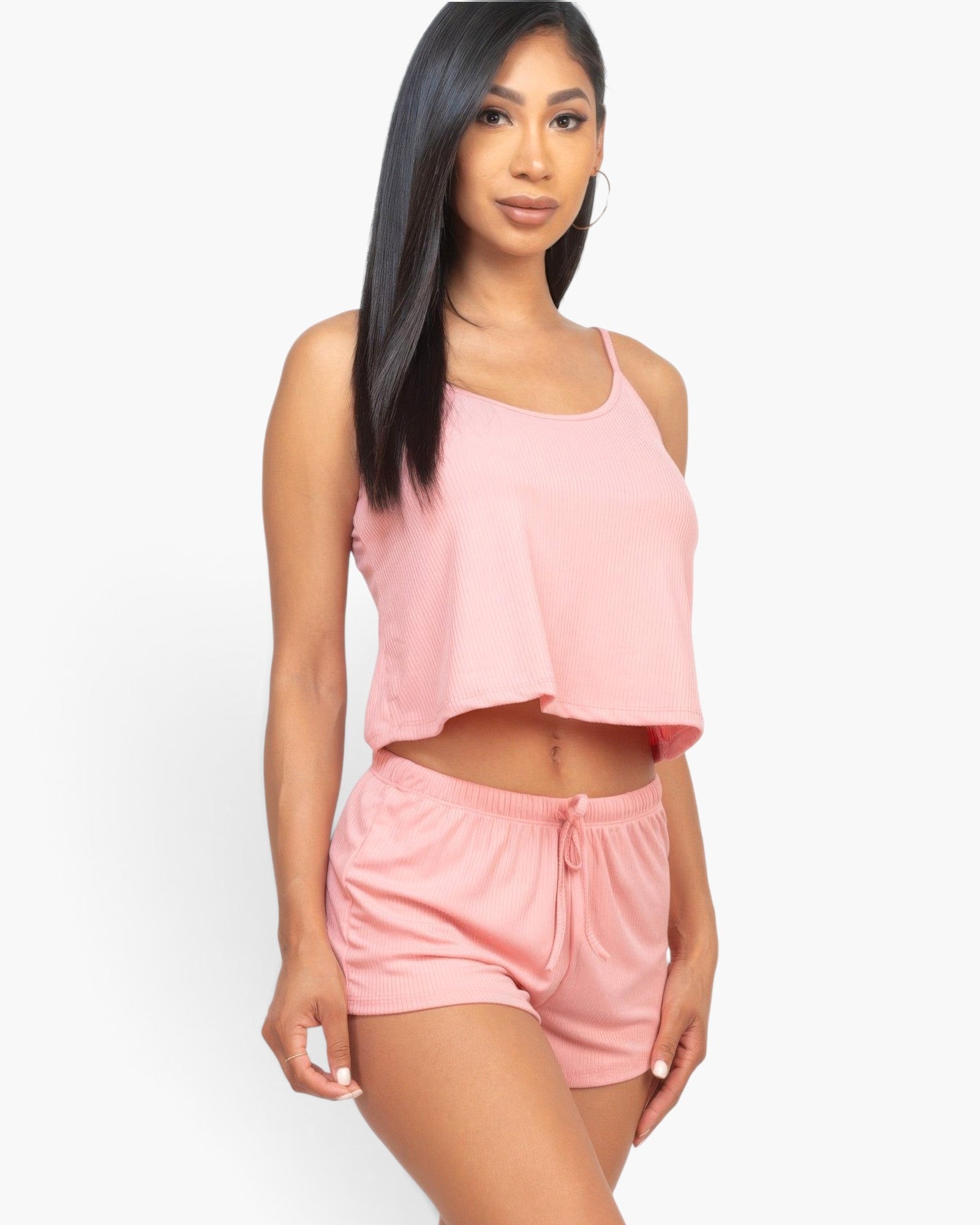 Beach Rose Co. blush pink ribbed strappy top and shorts lounge set worn by a woman with long dark hair