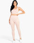 Beach Rose Co. blush pink ribbed crop top and high-waisted leggings set worn by a model on a white background