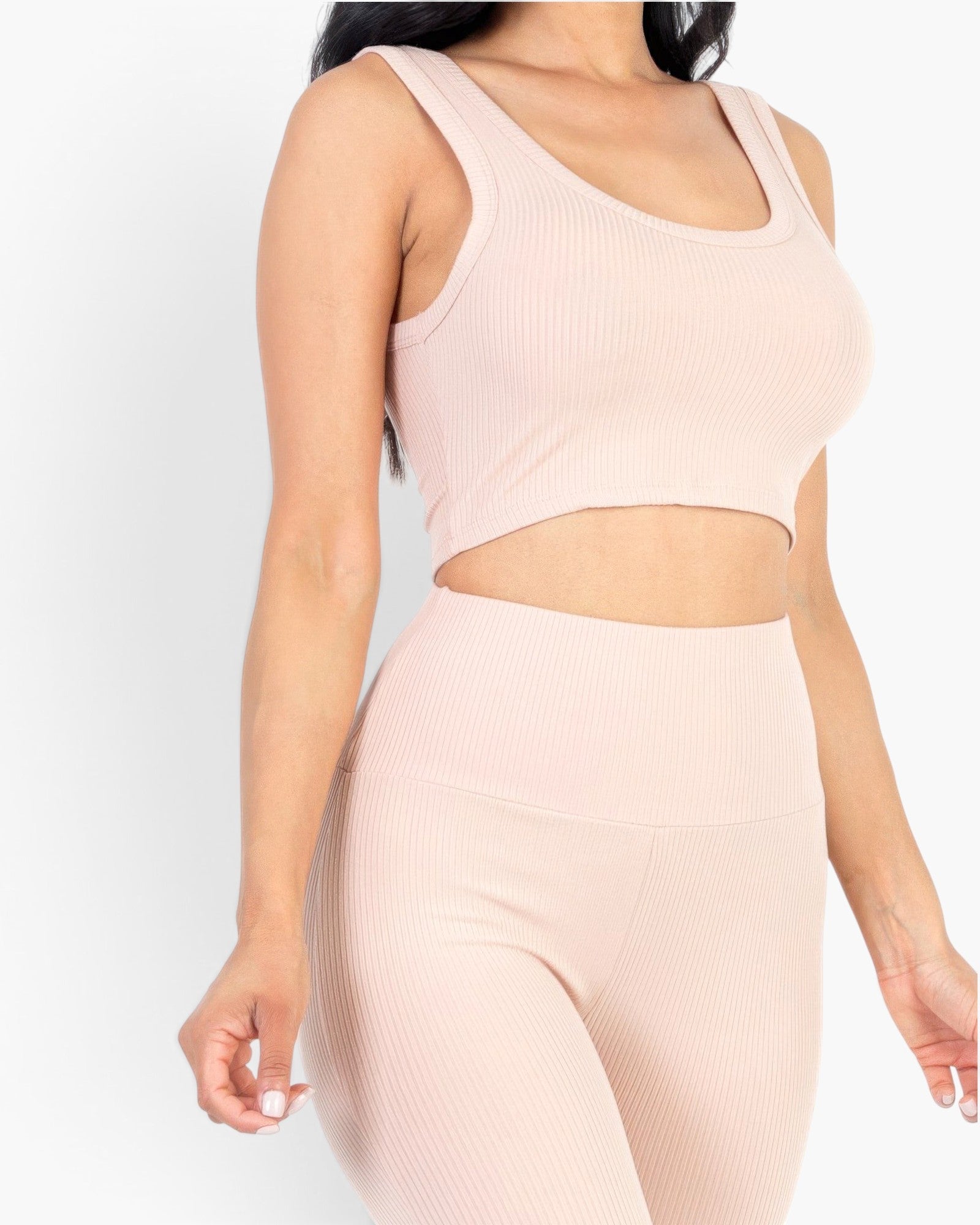 Beach Rose Co. blush pink ribbed crop top and high-waisted leggings set on a model against a white background.