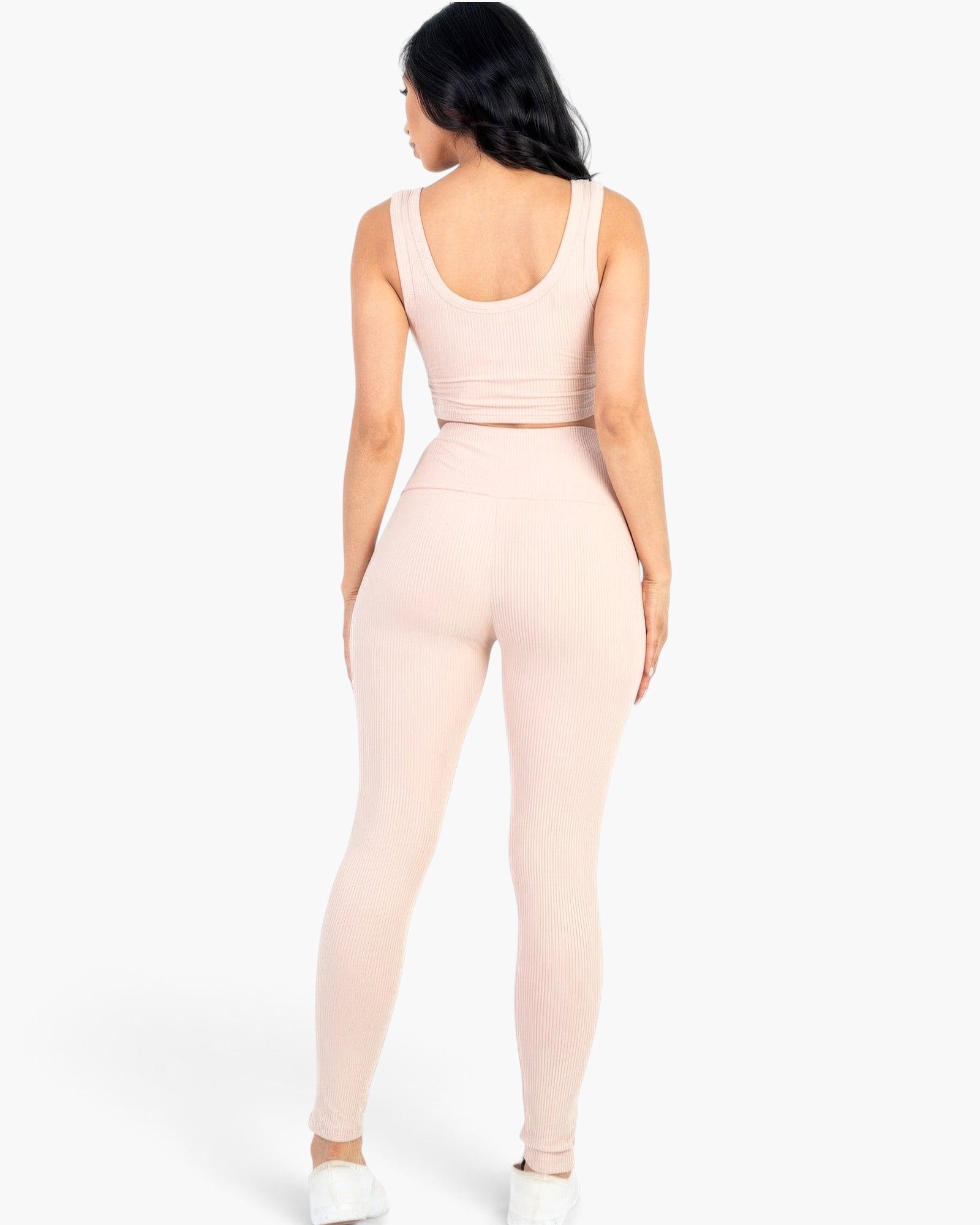 Beach Rose Co. blush ribbed crop top and high-waisted leggings set worn by a woman from the back view