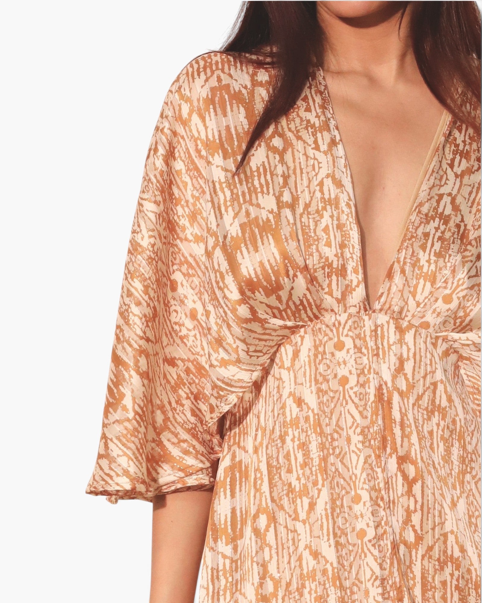 Beach Rose Co. bohemian maxi dress in shimmering gold and white chiffon with a deep V-neck and flowing cape sleeves.