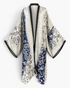 Beach Rose Co. Wanderlust boho kaftan in lightweight polyester with a blue and white paisley print and black trim.