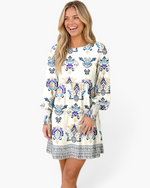 Beach Rose Co. cream mini dress with blue, navy, and taupe boho print, balloon sleeves, and gathered empire waist.