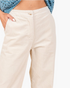 Beach Rose Co. bone corduroy wide-leg pants with a smooth front waistband and side pockets on a model.