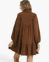 Back view of a Beach Rose Co. brown corduroy babydoll dress with balloon sleeves and a gathered yoke on a model.
