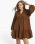 Beach Rose Co. brown corduroy babydoll dress with long balloon sleeves, split neckline, and ruffled hem on a model.