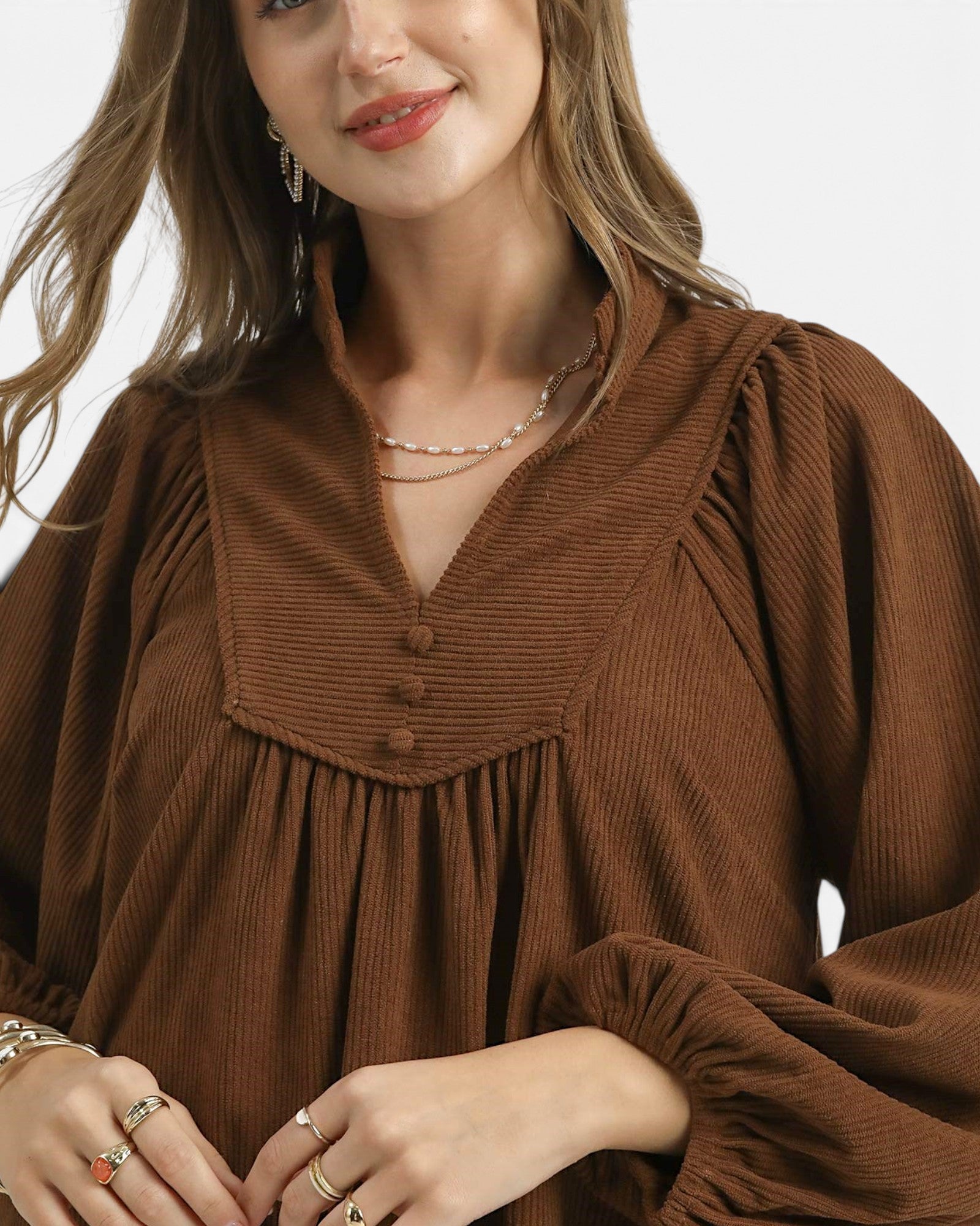 Beach Rose Co. brown corduroy babydoll dress with a split neckline, covered buttons, and gathered balloon sleeves.