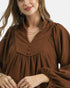 Beach Rose Co. brown corduroy babydoll dress with a split neckline, covered buttons, and gathered balloon sleeves.