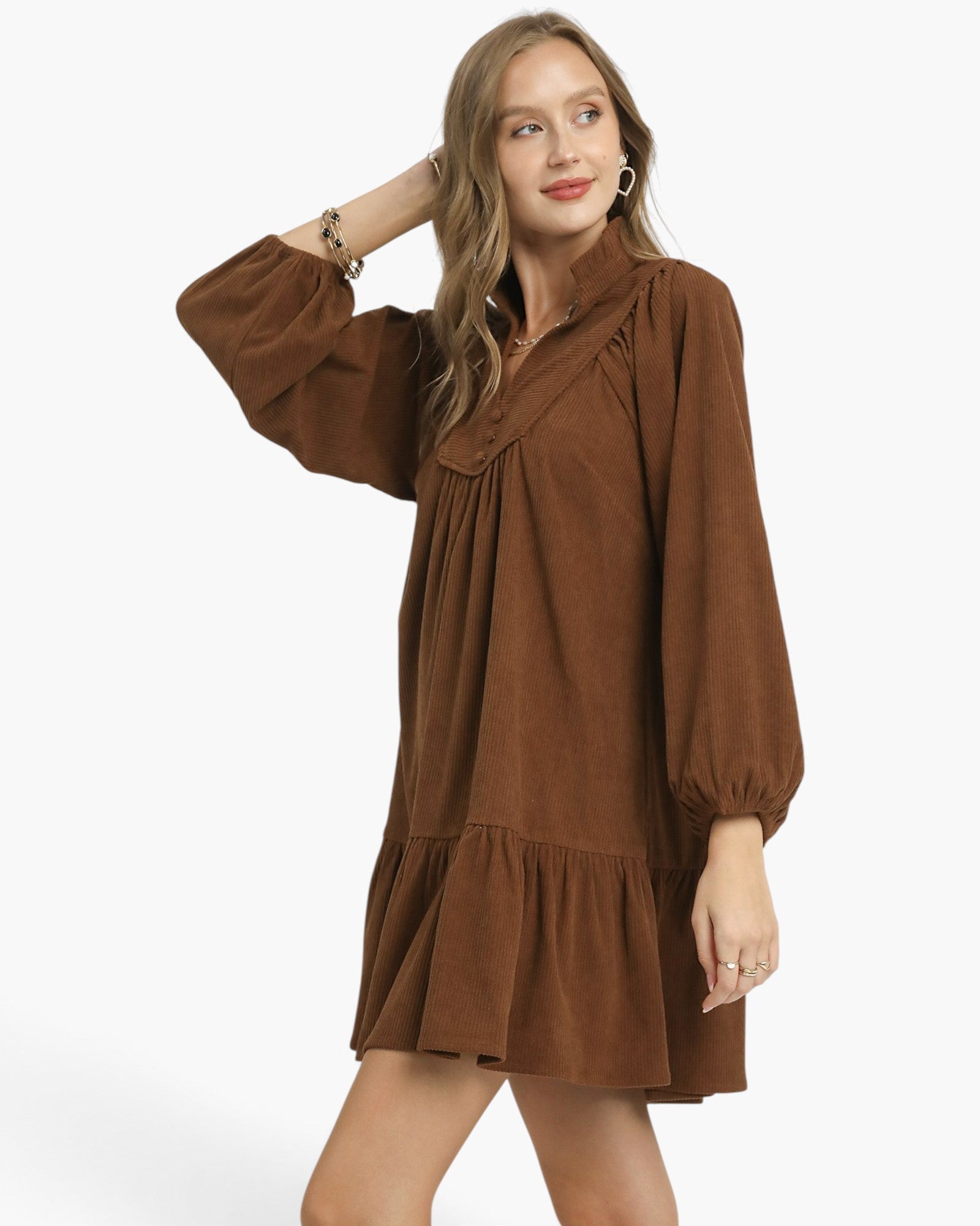 Beach Rose Co. brown corduroy babydoll dress with balloon sleeves, split neckline, and ruffled hem on a model.