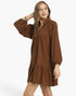 Beach Rose Co. brown corduroy babydoll dress with balloon sleeves, split neckline, and ruffled hem on a model.