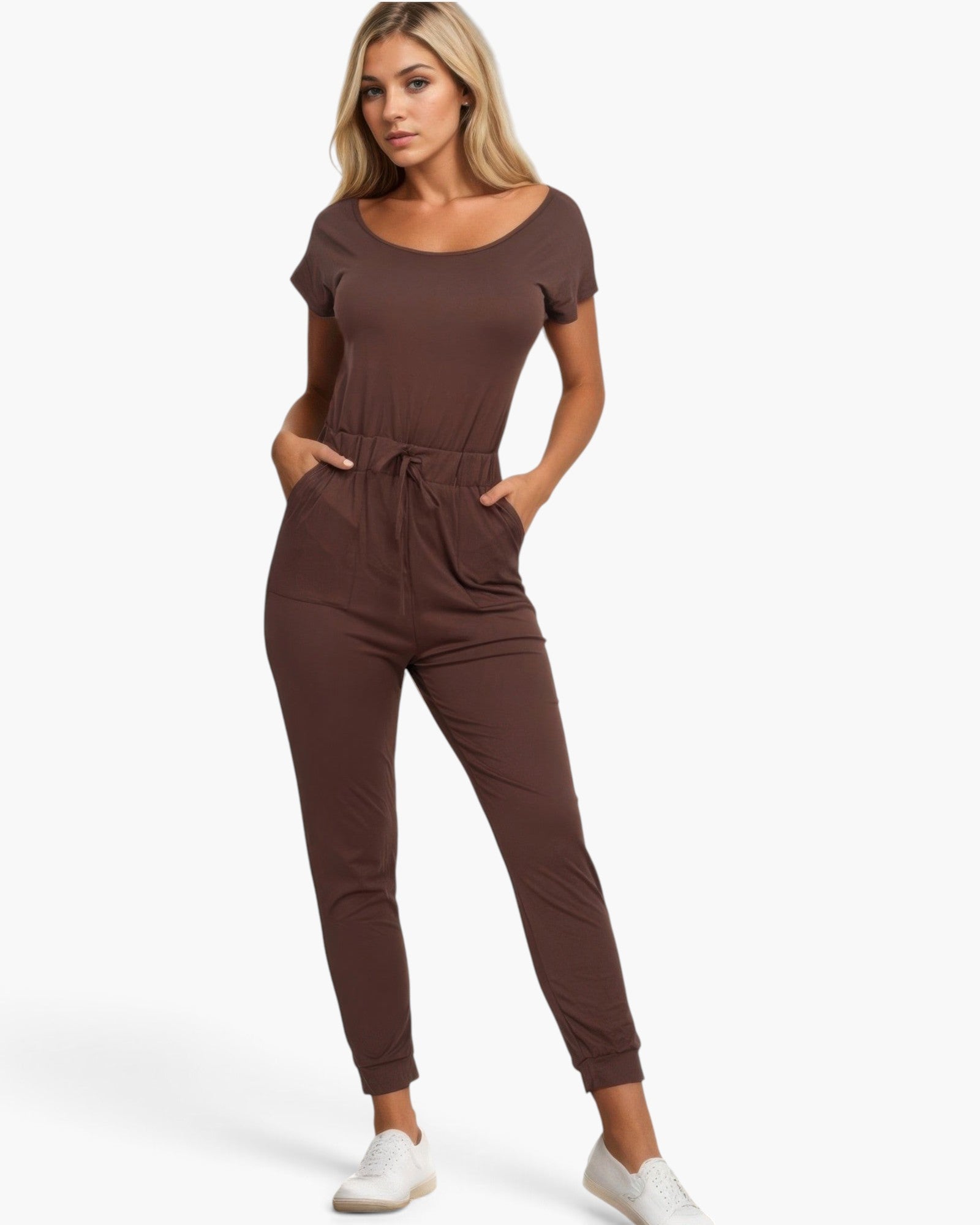 Beach Rose Co. brown two-way shoulder drawstring jumpsuit worn by a blonde model with white sneakers
