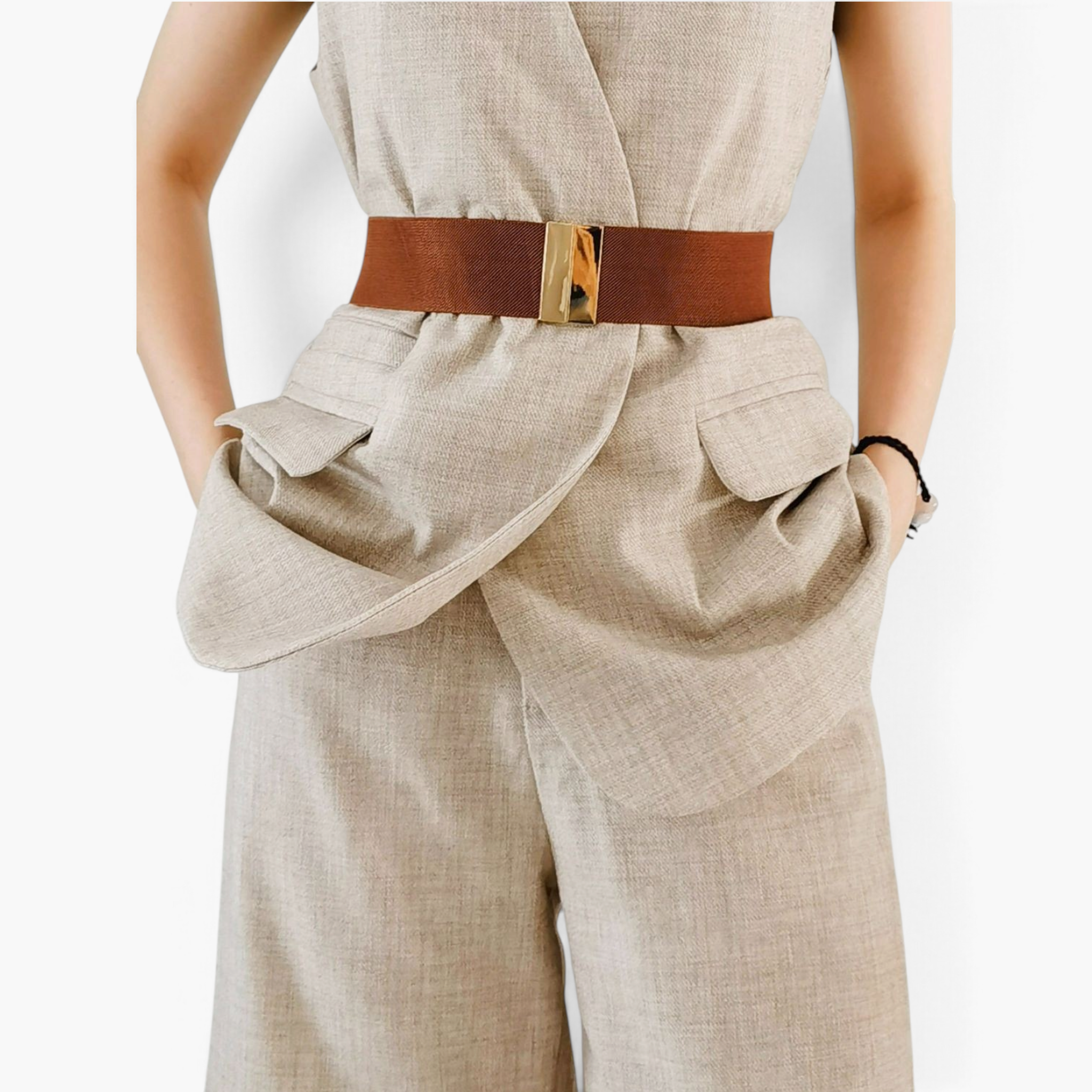 Beach Rose Co. wide brown elastic waist belt with a gold rectangular alloy clasp worn over a beige linen outfit.